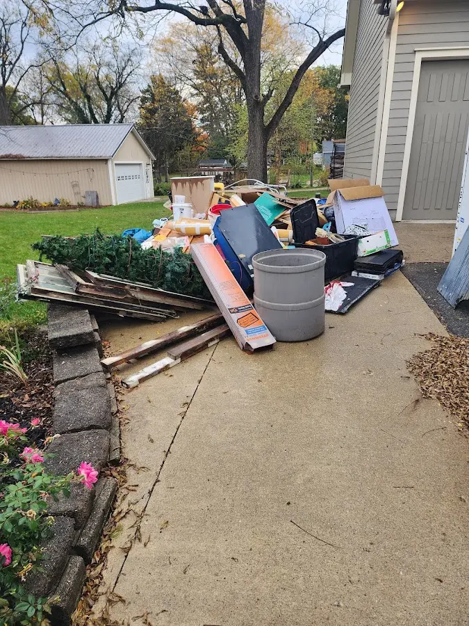 Dumpster being loaded with debris for Roofing Dumpster Rental in Bethany